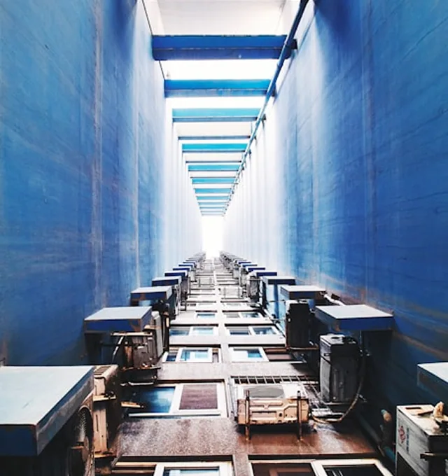 A data centre cold aisle photographed from below, racks receding into the distance